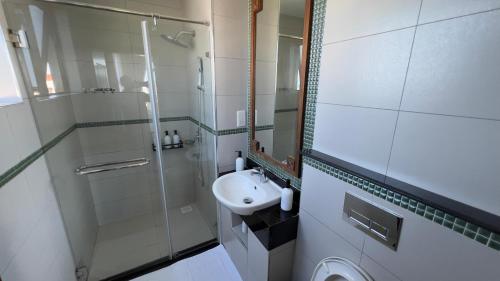 a small bathroom with a sink and a shower at Sultan palace Luxury Two bedrooms in Kilifi