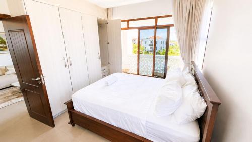 a small bedroom with a bed and a window at Sultan palace Luxury Two bedrooms in Kilifi