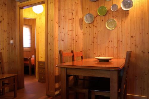 a dining room with a wooden table and chairs at Camping Oleiros in Oleiros