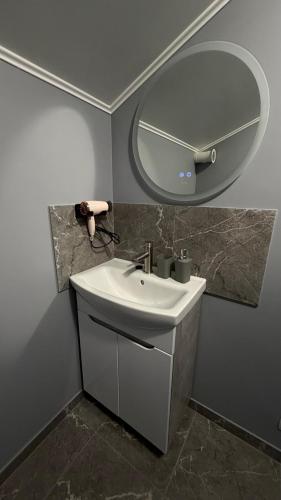 a bathroom with a sink and a mirror at HIT- house in Slavske