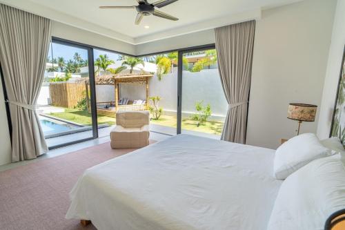 a bedroom with a large bed and large windows at Villa GAÏA - Luxury Tropical Villa - Private Pool in Lamai