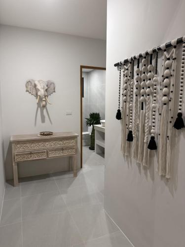a room with a table and a wall with knobs at Villa GAÏA - Luxury Tropical Villa - Private Pool in Lamai