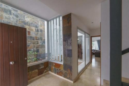 a hallway of a house with a stone wall at Chalet Adosado en Playa La Barrosa in Novo Sancti Petri