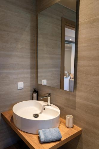 a bathroom with a white sink and a mirror at Filakas in Syvota