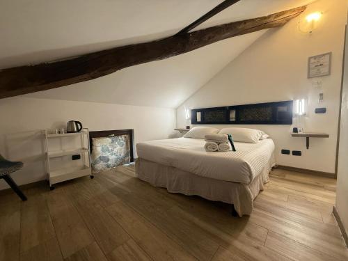 a bedroom with a large bed and wooden floors at Poste Regie - Milan Guest House in Milan