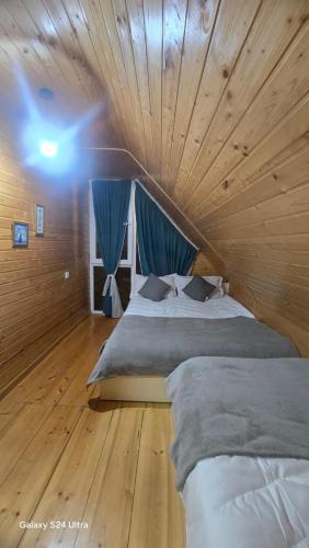 a bedroom with a wooden ceiling with two beds at Luxury Cottage Resort in Patara-Tsemi