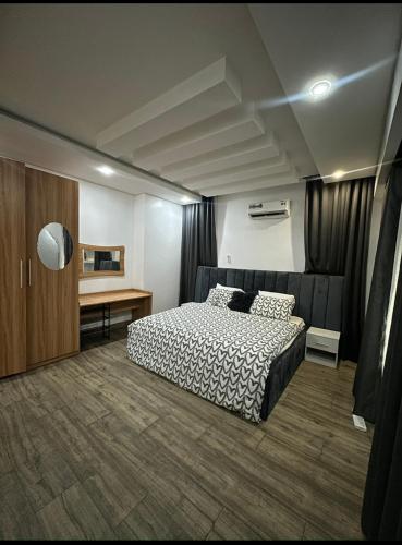 a bedroom with a bed and a desk at Executive Apartment in Anthony in Lagos