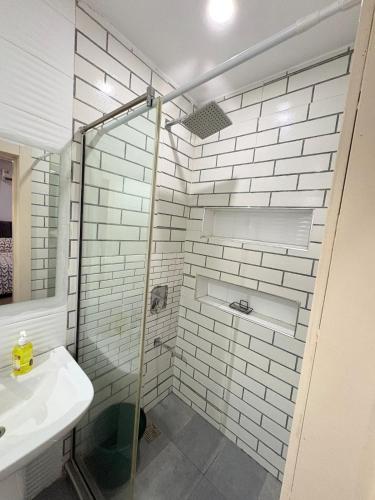 a bathroom with a shower with a sink and a toilet at Executive Apartment in Anthony in Lagos