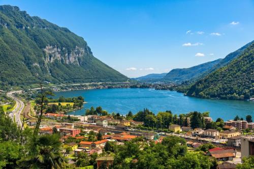 a view of a town next to a lake at La Rotonda Villa with Pool and Jacuzzi in Maroggia