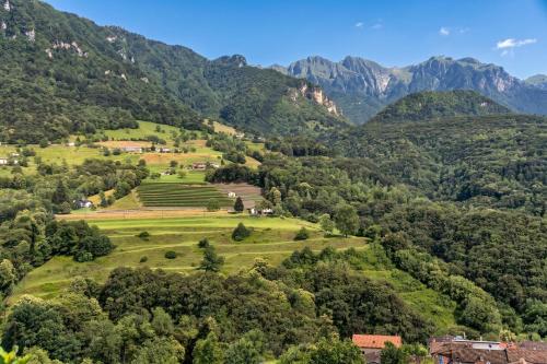 a view of a valley with mountains in the background at La Rotonda Villa with Pool and Jacuzzi in Maroggia