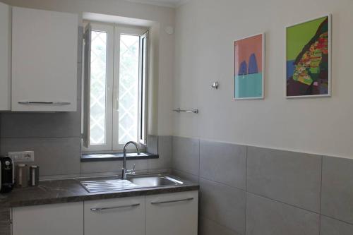a kitchen with a sink and a window at Villa Carbonilla in Torre del Greco