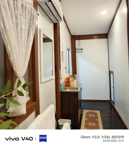 a room with a kitchen with a door and a sink at Ciao Bella in Dungun