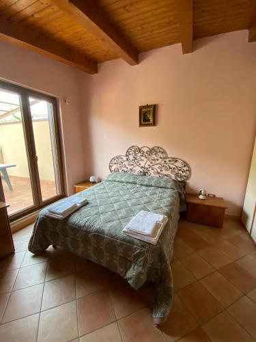 a bedroom with a bed and a large window at B&B LA ROSA in Salerno