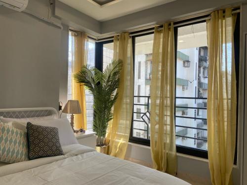 a bedroom with a bed and a large window at Fortune 603 in Mumbai