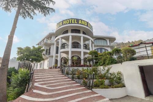 a hotel with stairs leading up to it at Treebo Kaler Hotel & Resorts in Nainital