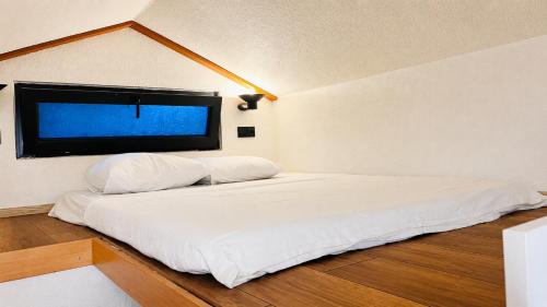 a white bed in a room with a window at Alya Hill Bodrum in Bodrum City