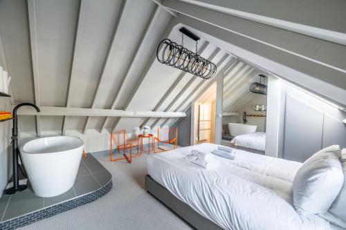 a bedroom with a large bed and a bath tub at La Retraite in Wolferton