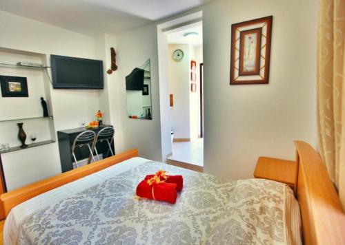 a bedroom with a bed with a red box on it at Haifa Guest House in Haifa