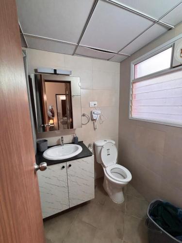 a bathroom with a toilet and a sink at Pool View 3 BR Adora, Goa Amoret Homes in Chicalim