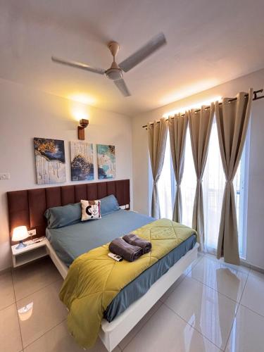 a bedroom with a bed with a yellow blanket at Pool View 3 BR Adora, Goa Amoret Homes in Chicalim