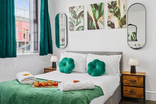 a bedroom with a bed with green sheets and pillows at Nile - Cosy Studio Apartment by Traboule Properties Ltd in Warrington