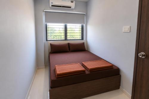 a small bed in a room with a window at Seasons Resorts in Jabalpur