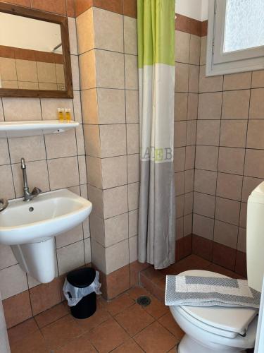 a bathroom with a sink and a toilet at Aurelia Rooms in Ios Chora