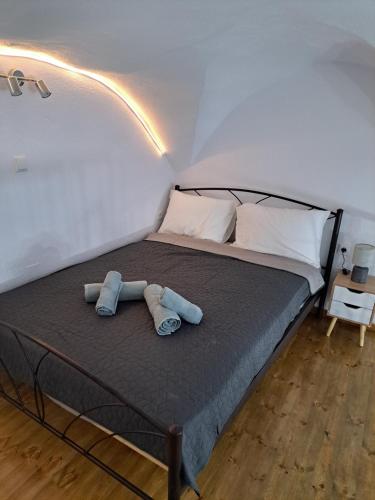 a bedroom with a bed with two towels on it at Patasa holiday apartment in Pyrgi