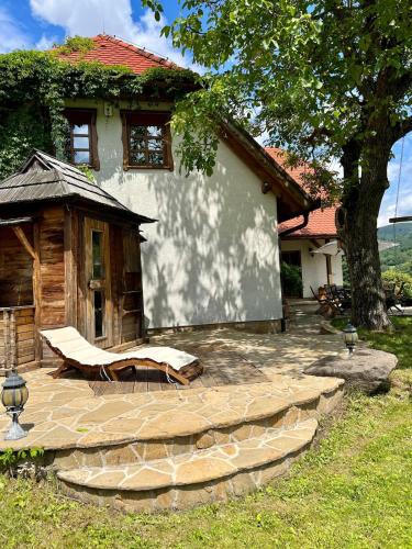 a patio in front of a house with a tree at Chalupa pri Ukoch s wellness, Bílé Karpaty in Matěk