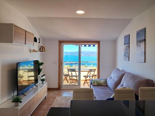 a living room with a couch and a television at Bella Vista in Portosin