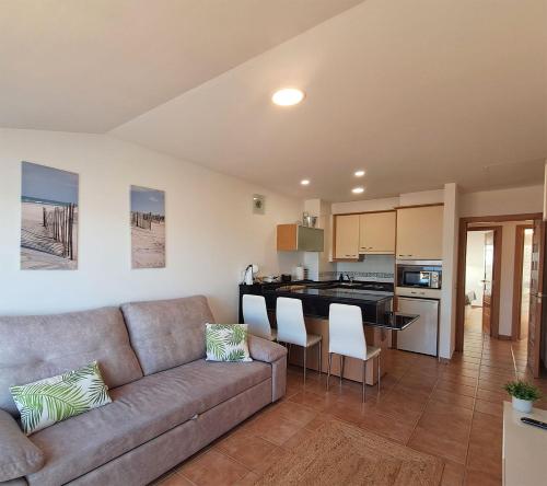 a living room with a couch and a kitchen at Bella Vista in Portosin