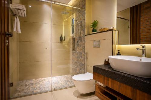 a bathroom with a sink and a toilet and a shower at The Rosendale Srinagar in Srinagar