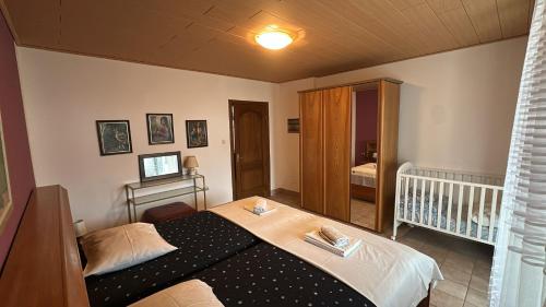 a small bedroom with a bed and a crib at Apartment Bepo in Senj