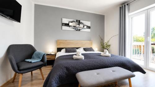 a bedroom with a bed and a chair at Villa Amoena with Pool and Sauna in Brtonigla