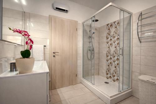 a bathroom with a shower and a sink at Villa Amoena with Pool and Sauna in Brtonigla