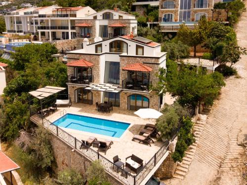 an aerial view of a house with a swimming pool at Villa Meltem in Kalkan