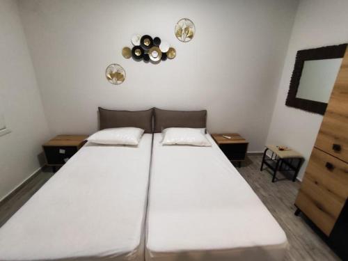 a bedroom with a large white bed in a room at Savvas's Room in Nea Kallikrateia