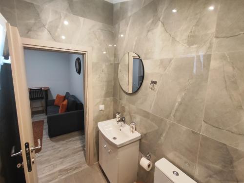 a bathroom with a sink and a mirror at Savvas's Room in Nea Kallikrateia