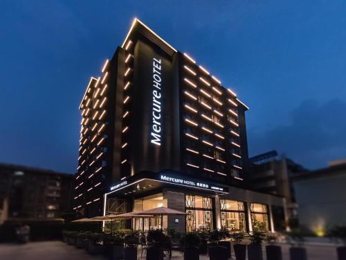 a large hotel building with a sign on it at Mercure Xi'an Downtown in Xi'an