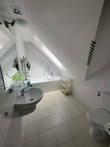 a white bathroom with a sink and a toilet at Polanki10 Łebski Dworek u Anity in Nowęcin