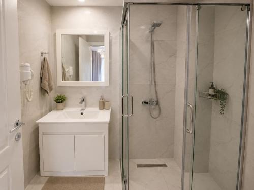 a bathroom with a shower and a sink at Hotel Mare in Ksamil