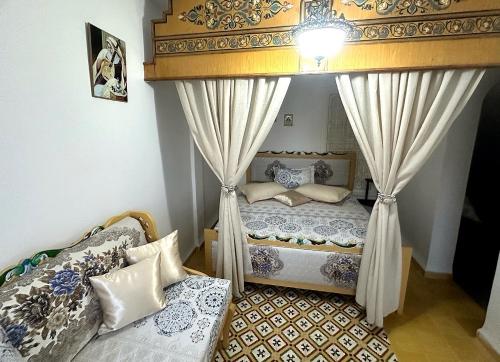 a bedroom with two beds and a canopy at Villa Island Zembra in El Haouaria