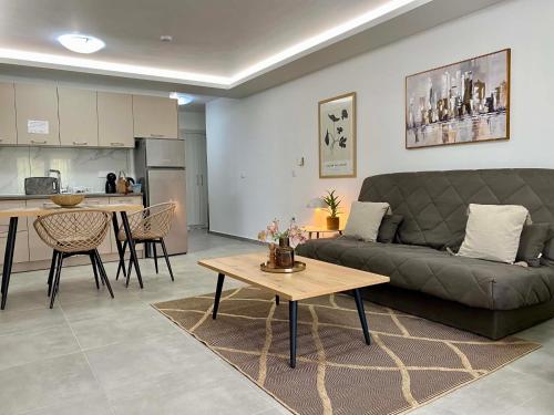 a living room with a couch and a table at Margarita's apartment 4 in Nea Peramos