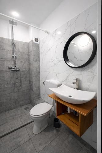 a bathroom with a sink and a toilet and a mirror at Vila Rubin in Eforie Nord