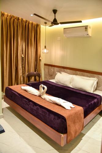 a bedroom with two beds with towels on them at Shri Guru Prasad in Belgaum