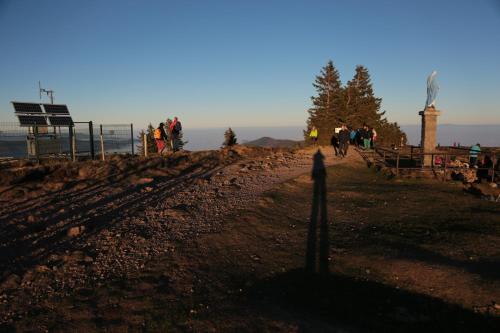 a group of people walking on a dirt hill at Le Holzberg et ses Suites in Osenbach