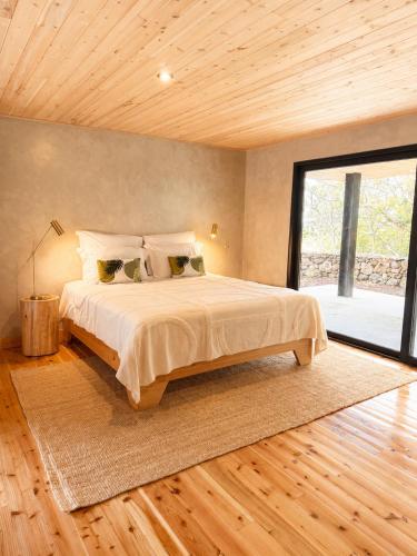 ein Schlafzimmer mit einem großen Bett und einem großen Fenster in der Unterkunft Aromas Studio in Terra Alta