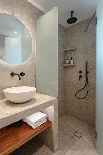 a bathroom with a sink and a shower at Ammolofos Luxury Apartment & suites in Naxos Chora