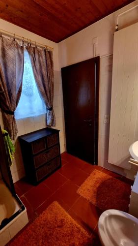 a bathroom with a toilet and a window and a sink at Ca'Neggio in Neggio