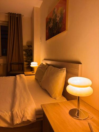 a bedroom with a bed and a table with a lamp at Liva in Ho Chi Minh City